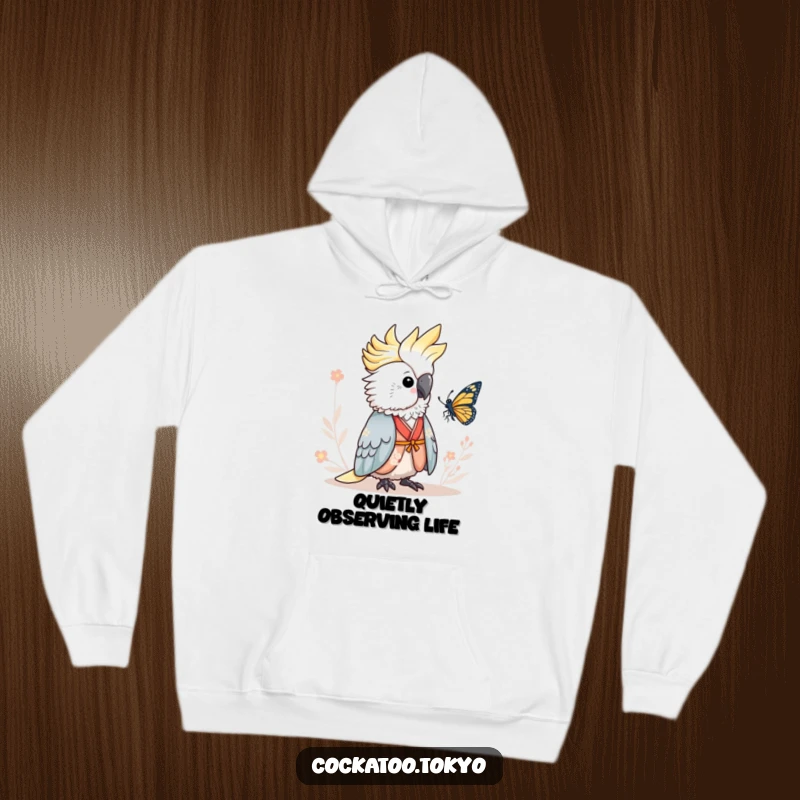 Funny Hoodie featuring an adorable cockatoo in a serene kimono, peacefully observing a butterfly, offering warmth and humorous tranquility.